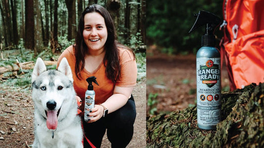 Blogger, She Travels, holds up Ranger Ready Picaridin 20% Bug Spray with Husky Dog in the woods in Washington State Parks. Ranger Ready Repellents sits on the grounds in the forest.